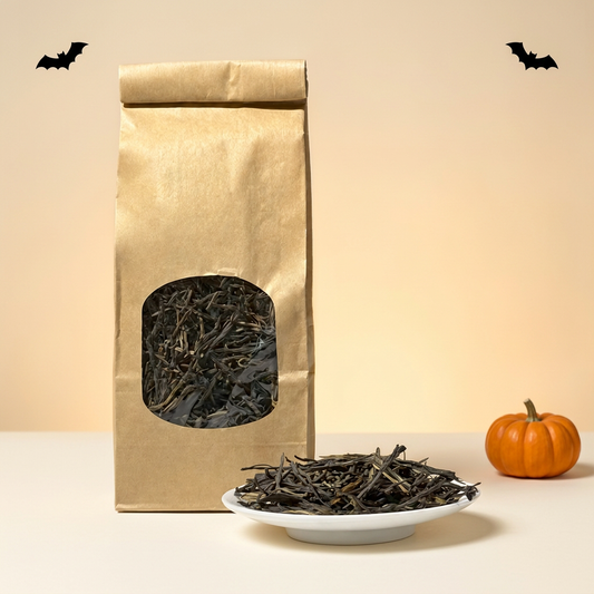 AI-edited Halloween scene based on Antrilea’s loose-leaf black tea product photo, featuring the kraft tea bag and dry leaves with seasonal background accents.